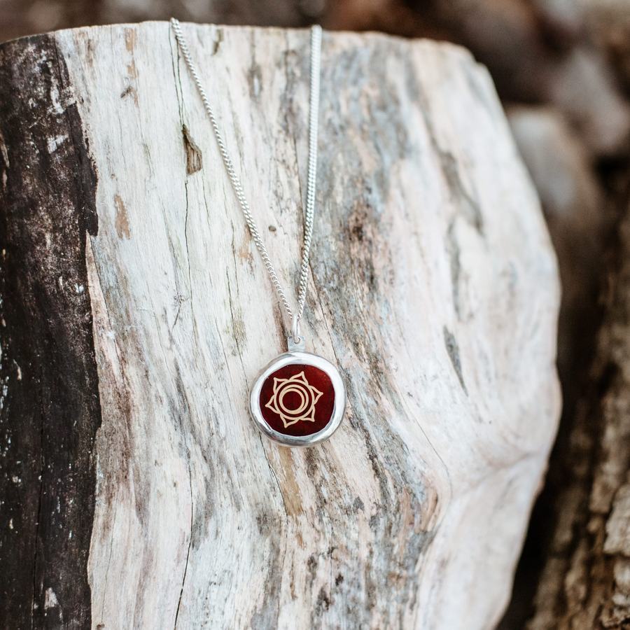 Sacral chakra amulet with engraved red stone