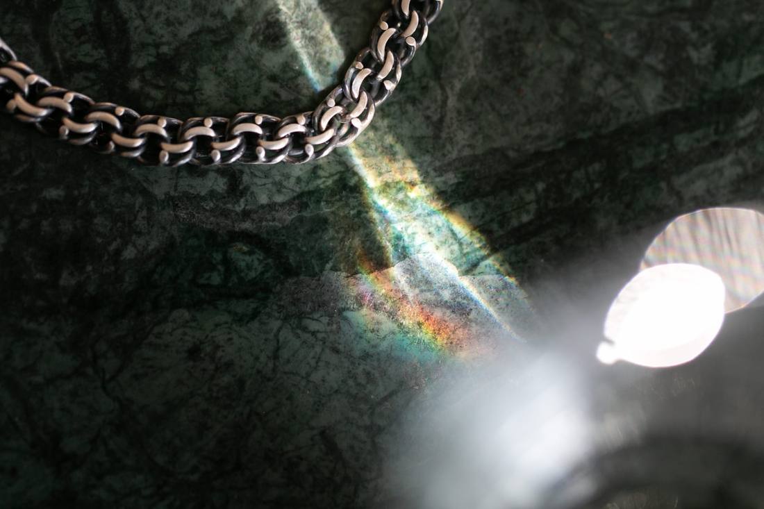 Handcrafted silver chain by Amanita on green marble